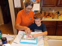 08-putting_candles_on_Daddy's_Carvel_ice_cream_cake_for_his_birthday