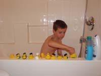 17-taking_a_bath_and_having_fun_playing_with_all_his_rubber_duckies