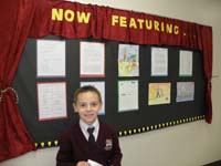 35-Kenny_in_front_of_the_'Now_Featuring...'_board_outside_class-two_of_the_eight_are_his-Wow-great_job