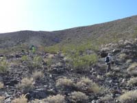 21-Kay_and_Poppy_heading_up_steep_slope_with_some_loose_rocks_to_ridge_and_then_peak