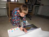 65-Mommy's_shopping_so_we_need_to_quickly_wrap_her_Christmas_present-Kenny_helps