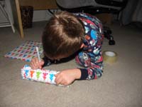66-Kenny_was_very_happy_to_help_wrap_the_presents