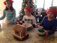 06-Brooke,Kenny,Leyna_making_a_gingerbread_house_on_Christmas_Eve