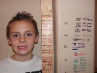 71-measuring_Kenny's_height-use_a_piece_of_wood_to_measure_height