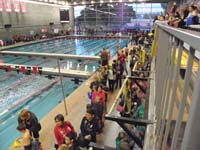 02-0715am-Mommy_helping_Kenny_get_ready_for_the_swim_meet-lots_of_people-UNLV_Natatorium