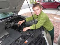 01-Kenny_working_on_Daddy's_car-Daddy_showed_him_how_to_replace_a_mass_air_flow_sensor