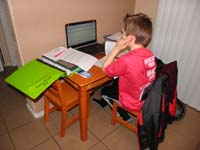 30-Kenny_doing_his_homeword_at_his_desk_and_reads_emails_from_his_laptop