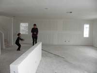 07-Kenny_and_Mommy_jumping_for_joy_in_the_great_room_and_kitchen_area