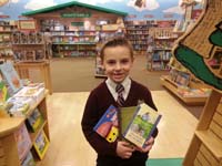 14-Kenny_picks_out_new_books_to_read_from_the_store