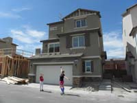 38-20150321-Kenny_and_Mommy_with_house-concrete_poured,roof_installed,wall_built