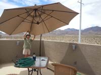09-three_weeks_after_moving_in,we_finally_install_rooftop_deck_umbrella