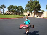 47-Kenny_carries_his_golf_clubs-time_to_try_the_driving_range