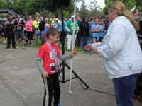 22-Kenny_wins_1st_place_for_his_age_group-he's_receiving_his_medal