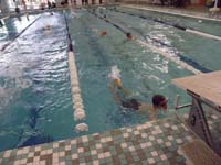 04-Kenny_swimming-kids_swim_laps,go_under_lane_separator,then_swims_next_lane