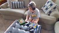 21-Kenny_multitasking-watching_a_show_on_his_Kindle_and_playing_with_Guardians_of_Galaxy_Lego