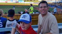 25-Daddy,Kenny_at_51s_baseball_game-Kenny_showing_off_players_cards_he_received_for_free