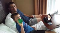 08-Daddy_and_Kenny_relaxing_in_the_hotel_room_watching_a_movie_in_bed_on_the_Kindle