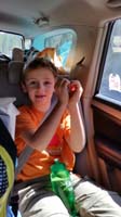 01-Kenny_makes_a_heart_with_his_hands_while_in_the_car