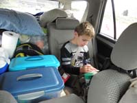 03-Kenny_is_boxed_in_with_camping_supplies_in_the_car