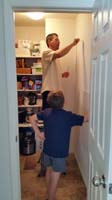 66-Kenny_watching_Daddy_install_an_organizer_in_pantry_for_Mommy