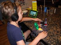 29-this_how_Kenny_likes_to_relax_before_bed-watches_show_on_Kindle,play_with_snap_circuits