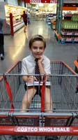 37-Kenny_riding_in_the_cart_through_Costco_doing_his_homework_while_Mommy_shops