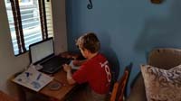 38-finishes_his_homework_at_his_desk_before_baseball_game