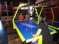 33-later_that_day-laser_tag_party_for_Tara's_9th_birthday-playing_air_hockey_with_Tara