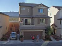 74-Mommy_and_Kenny_presenting_our_house-photo_for_Christmas_letter