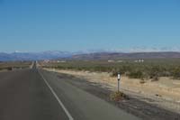 02-approaching_Amargosa-Lathrop_Wells_for_break-snow_covered_peaks_in_distance