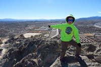 07-Kenny_on_peak_pointing_to_his_school