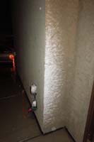 24-wind_blown_snow_on_side_of_house_by_front_door