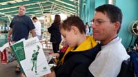 09-Kenny_resting_on_Daddy_while_he_reads_baseball_rules_since_managing_team