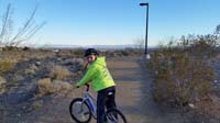 01-Kenny_on_his_bike_through_the_exercise_path_by_Knickerbocker_Park-Las_Vegas_Strip_in_background