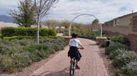 04-riding_his_bike_through_the_Promenade_in_our_community