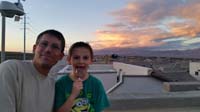 13-Daddy_and_Kenny_on_rooftop_deck_enjoying_the_sunset_with_storm_in_distance