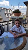 40-Kenny_doing_his_homework_on_the_balcony_with_blooming_Aloe_Vera