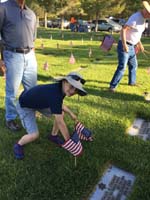 04-Kenny_placing_a_flag_in_the_ground