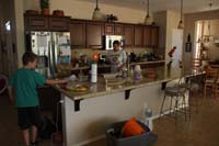 69-visiting_Baba_and_Poppy-Kenny_likes_playing_with_his_trains_around_kitchen_island