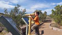 070-Kenny_looking_through_telescope_at_Bandalier_while_Daddy_hiking