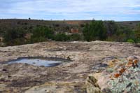 09-scenery_with_Rim_Rock_House_in_distance_and_tenaja_with_water_from_recent_rain,but_nothing_swimming