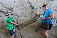 036-Kenny_and_Mommy_get_to_touch_a_dinosaur_fossil_in_the_rock