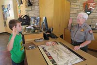 082-Kenny_takes_Junior_Paleontologist_oath-last_badge_for_trip-total_of_18