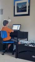 01-Summer_fun-Kenny_practices_typing_on_his_laptop_using_a_typing_turor_program