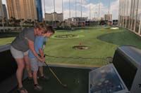 13-Mommy_shows_Kenny_how_to_hold_the_club-Daddy_is_useless_to_help_with_this_sport