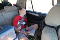 31-taking_a_nap_while_driving_to_Snow_Canyon_State_Park_for_1_night_camping_with_LVMC-he_hates_reading_Big_Red