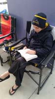 06-next_morning-warm-ups_done-reading_Big_Red_for_school_book_report_before_meet_starts