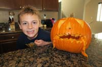 30-Kenny_and_carved_pumpkin-Daddy_added_some_'flesh'-pumpkin_is_a_carnivore