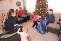 44-Kenny_pulls_out_the_gifts_from_the_big_bag-Wade_hands_them_to_the_appropriate_person