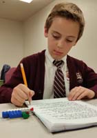 17-Kenny_practicing_writing_to_describe_what_he_see_for_Write_It_Do_It_practice_after_school